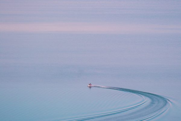 person riding on boat on body of water during daytime